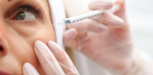 Professional beautician making botox facial injection